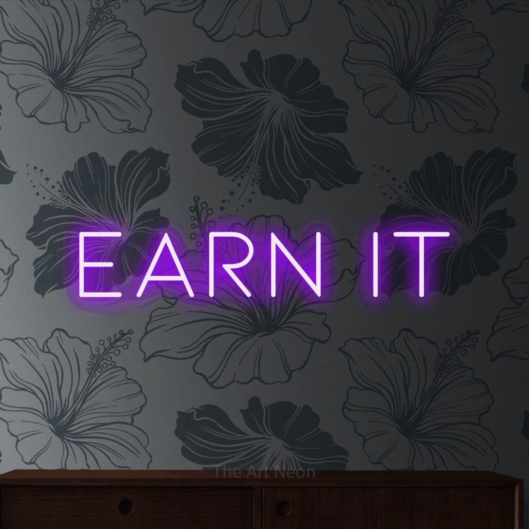 LED neon sign reading “EARN IT”, arranged in a single line.