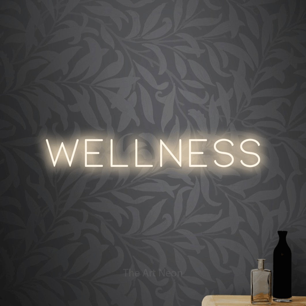 LED neon sign reading “wellness”, arranged in a single line.