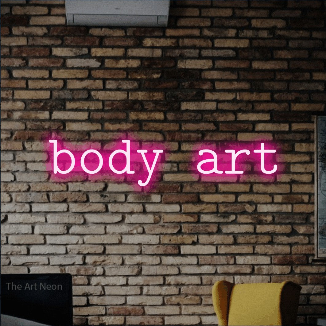 LED neon sign reading “body art”, arranged in a single line.