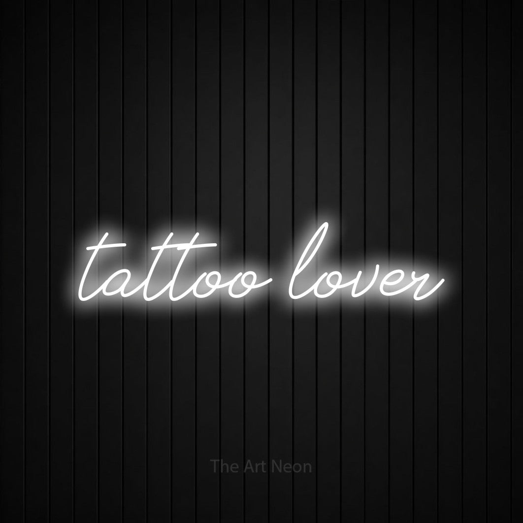 LED neon sign reading “tattoo lover”, arranged in a single line.