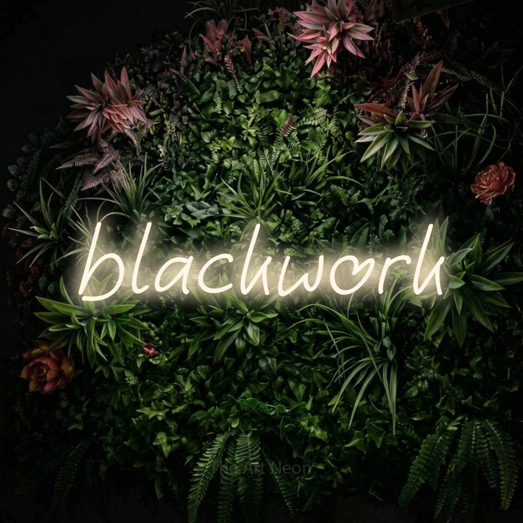 LED neon sign reading “blackwork”, arranged in a single line.
