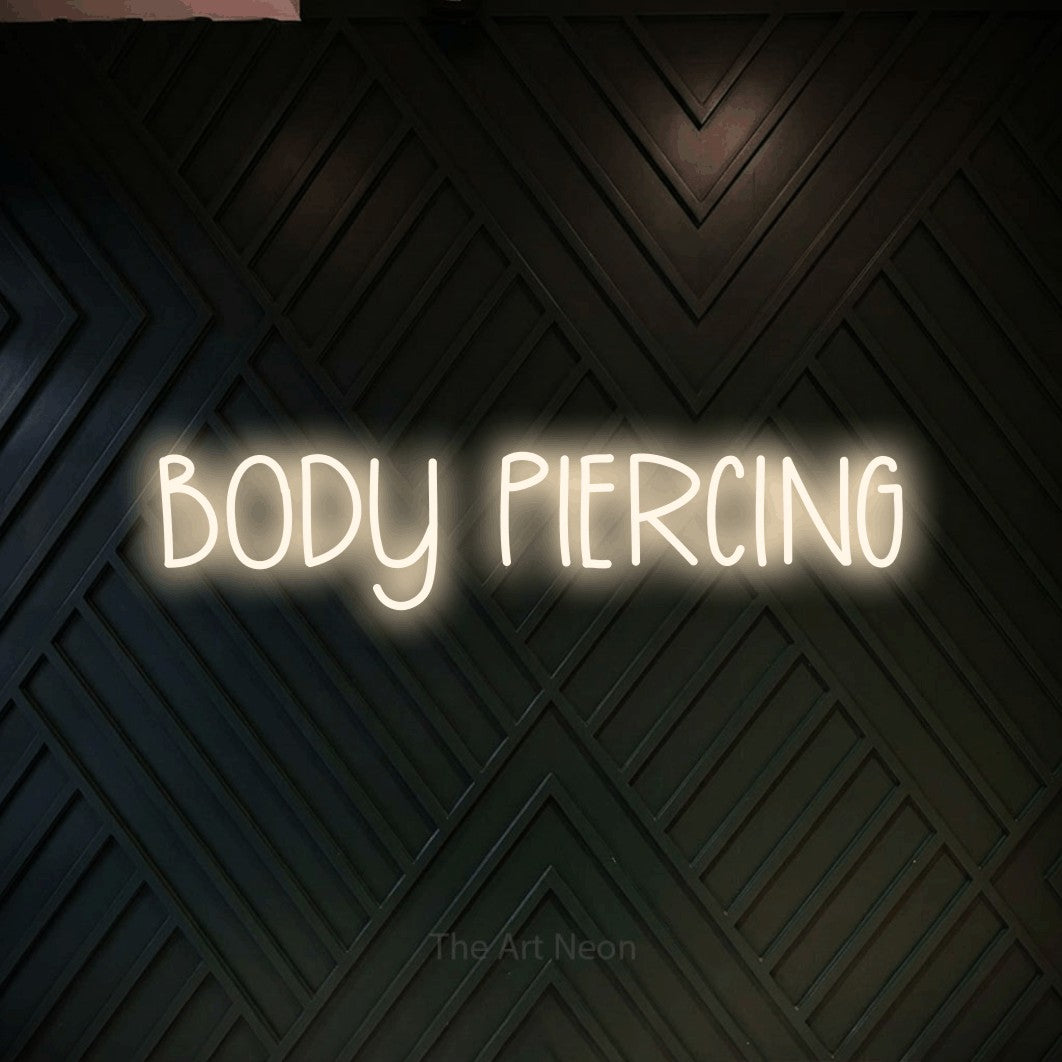 LED neon sign reading “BODY PIERCING”, arranged in a single line.