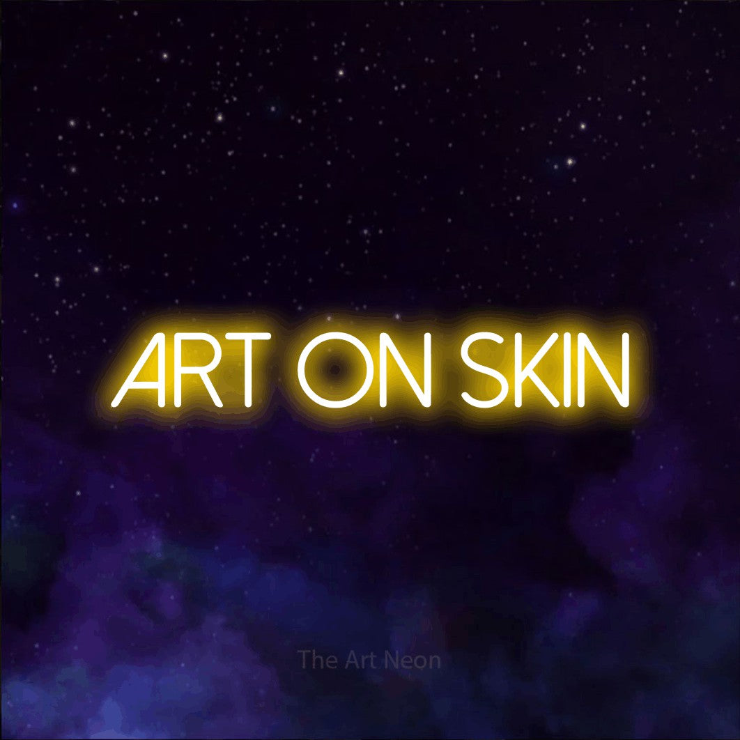 LED neon sign reading “art on skin”, arranged in a single line.