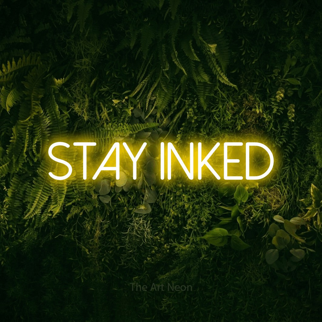 LED neon sign reading “Stay inked”, arranged in a single line.
