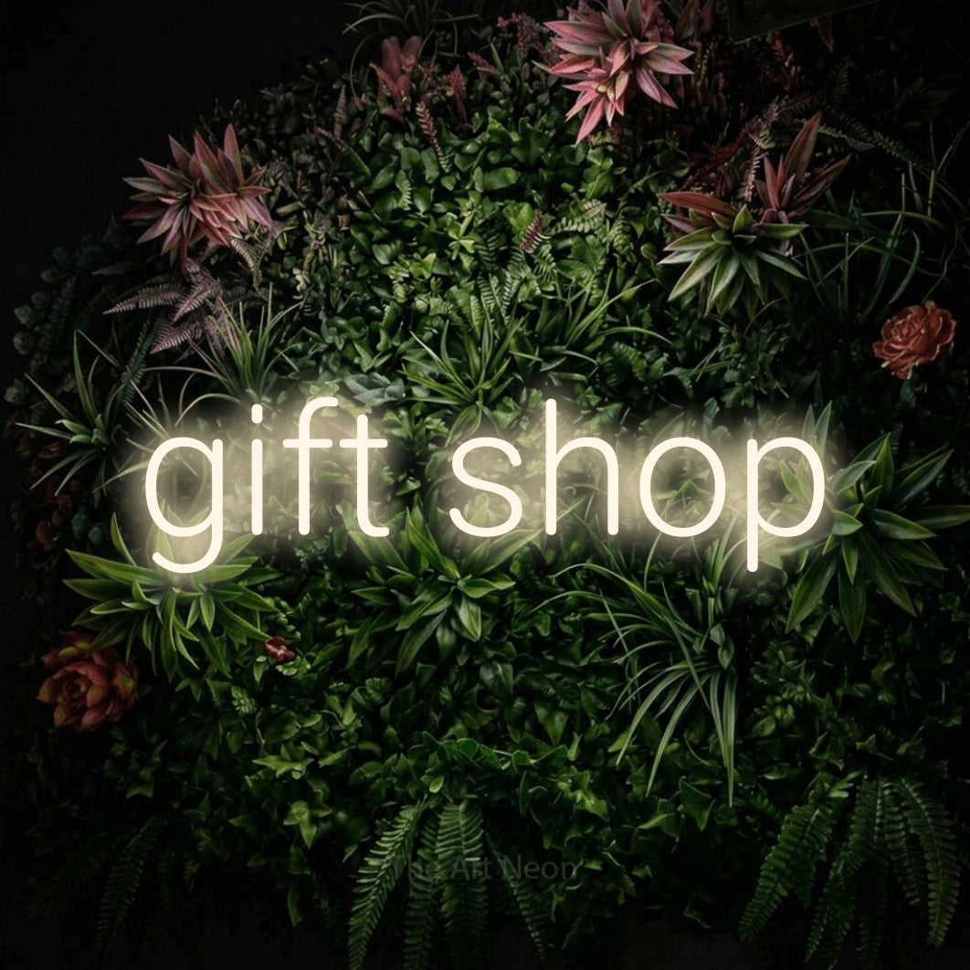 LED neon sign reading “gift shop”, arranged in a single line.