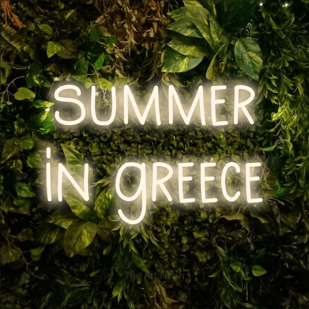 LED neon sign reading “summer in greece”, arranged in two lines.