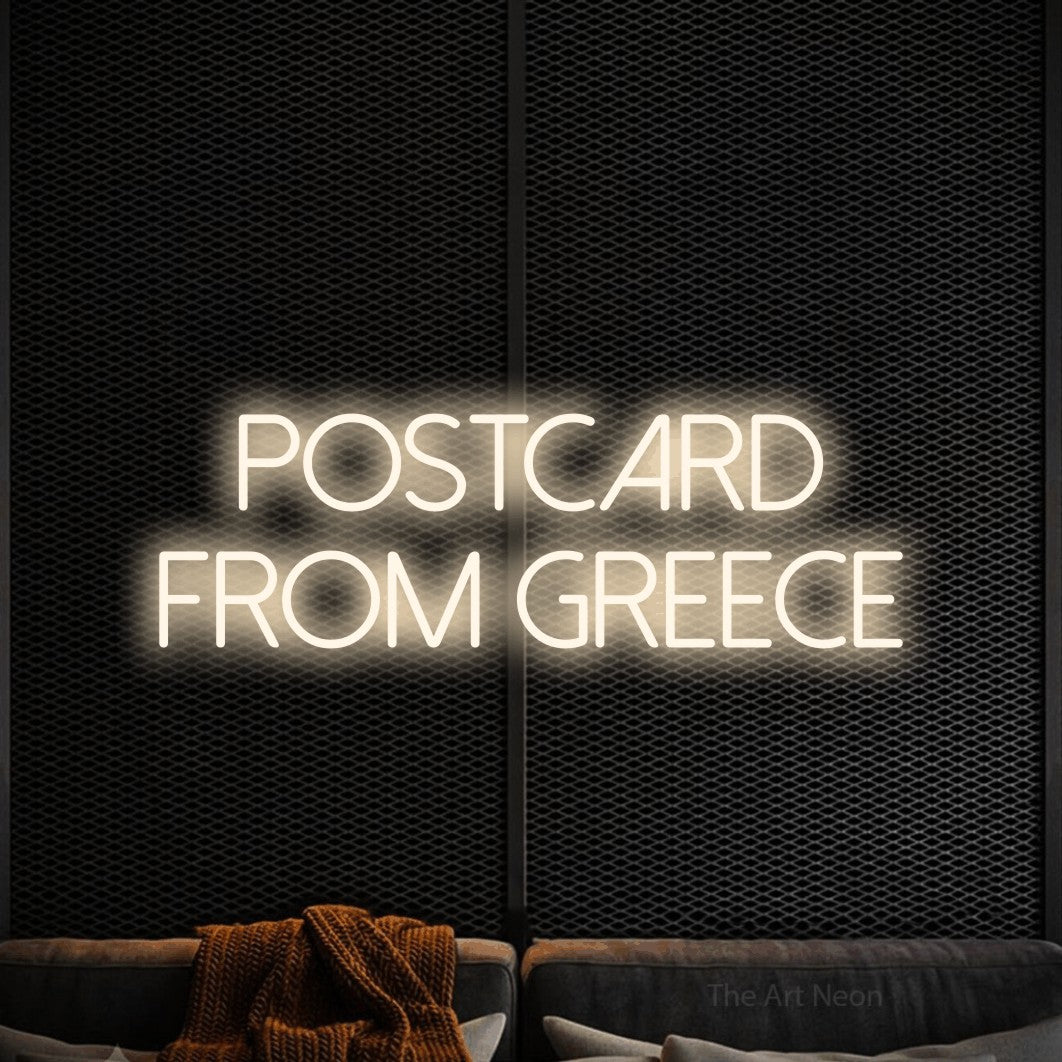 LED neon sign reading “Postcard From Greece”, arranged in two lines.