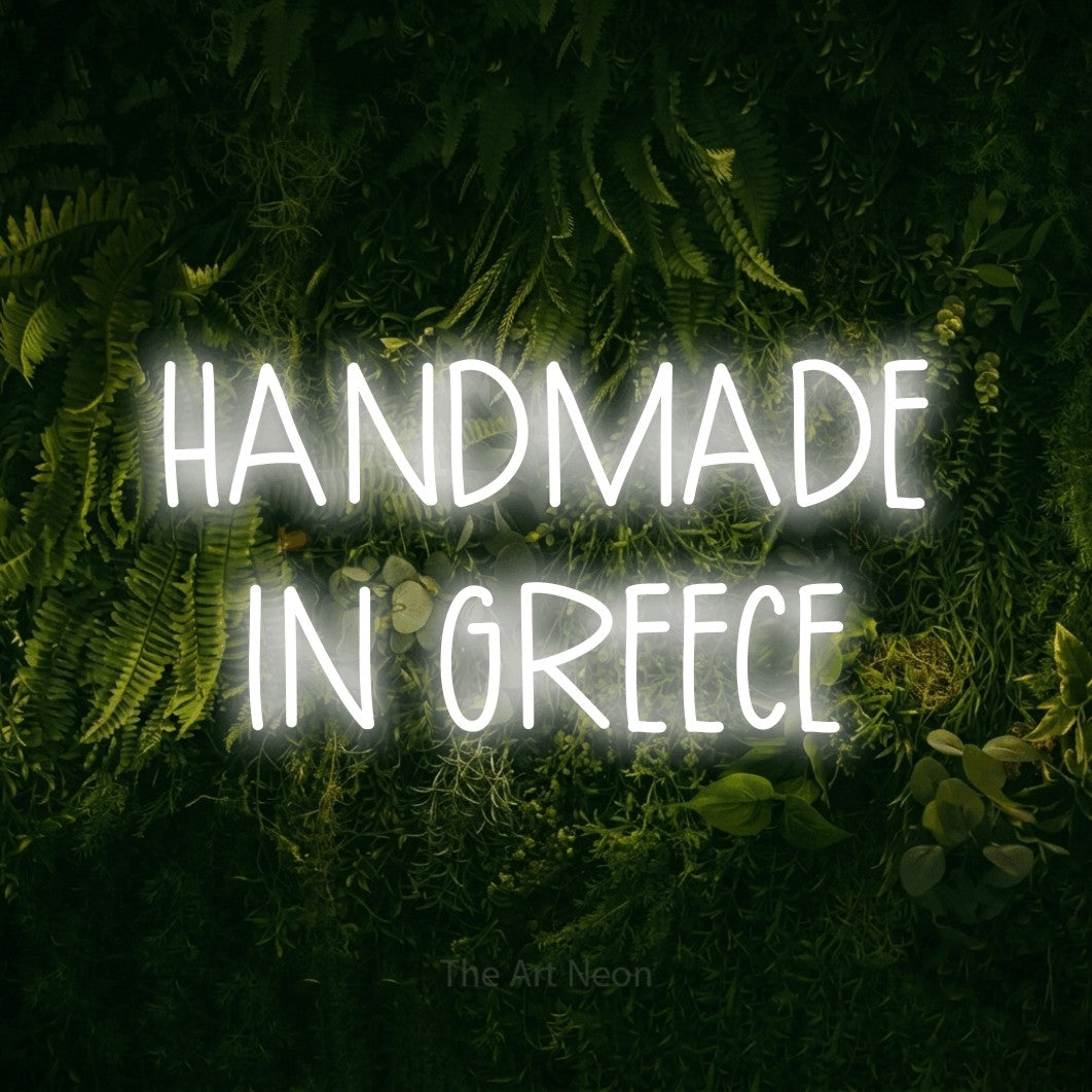 LED neon sign reading “HANDMADE IN GREECE”, arranged in two lines.