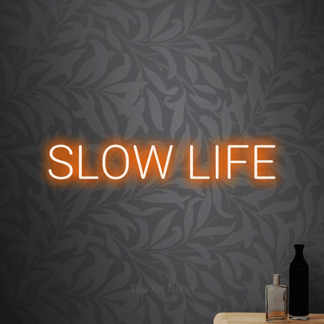 LED neon sign reading “SLOW LIFE”, arranged in a single line.