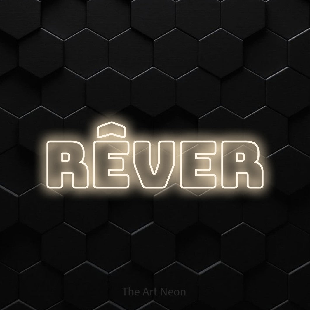 LED neon sign reading “RÊVER”, arranged in a single line.