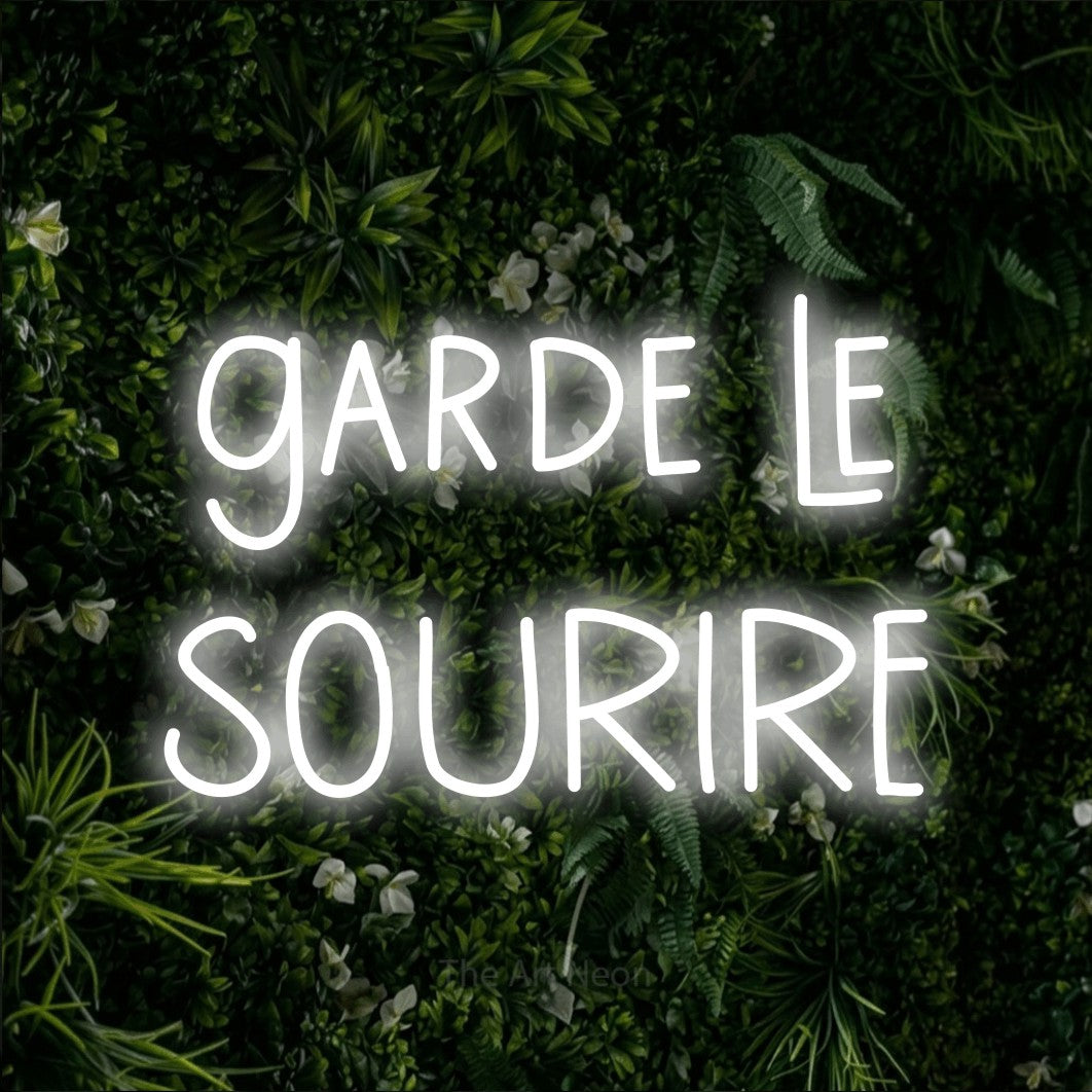 LED neon sign reading “garde le SOURIRE”, arranged in 2 lines.