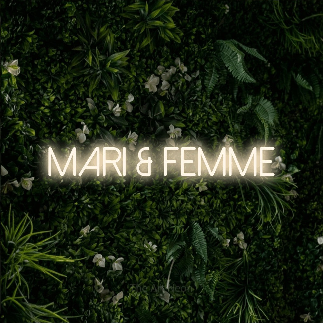 LED neon sign reading “MARI & FEMME”, arranged in a single line.