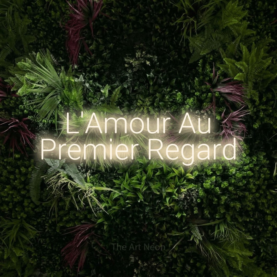LED neon sign reading “L'Amour Au Premier Regard”, arranged in 2 lines.