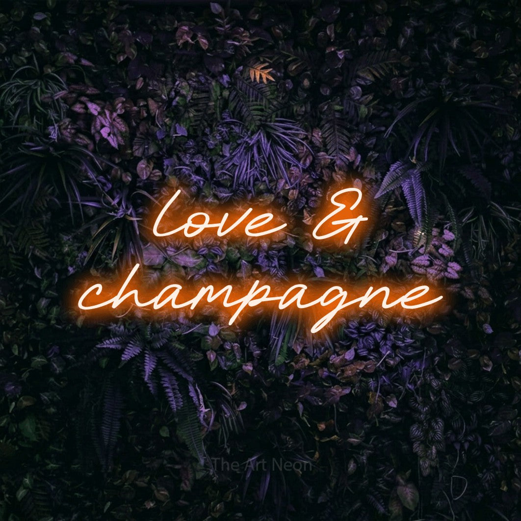 LED neon sign reading “love & champagne”, arranged in 2 lines.