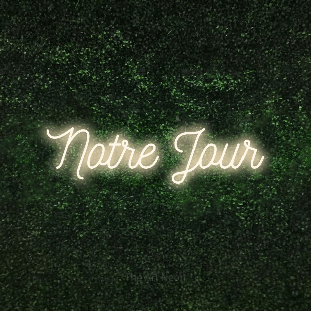 LED neon sign reading “Notre Jour”, arranged in a single line.