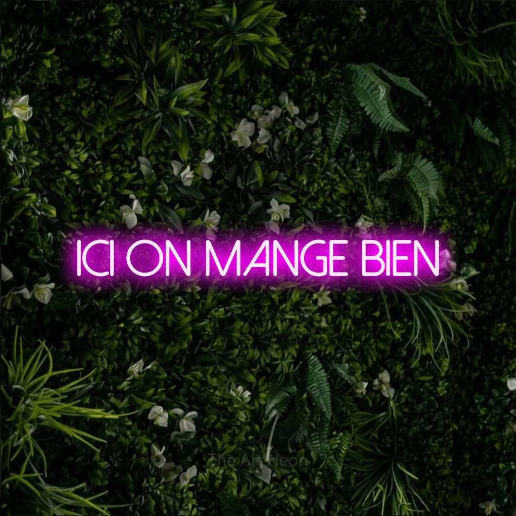 LED neon sign reading “ICI ON MANGE BIEN”, arranged in a single line.