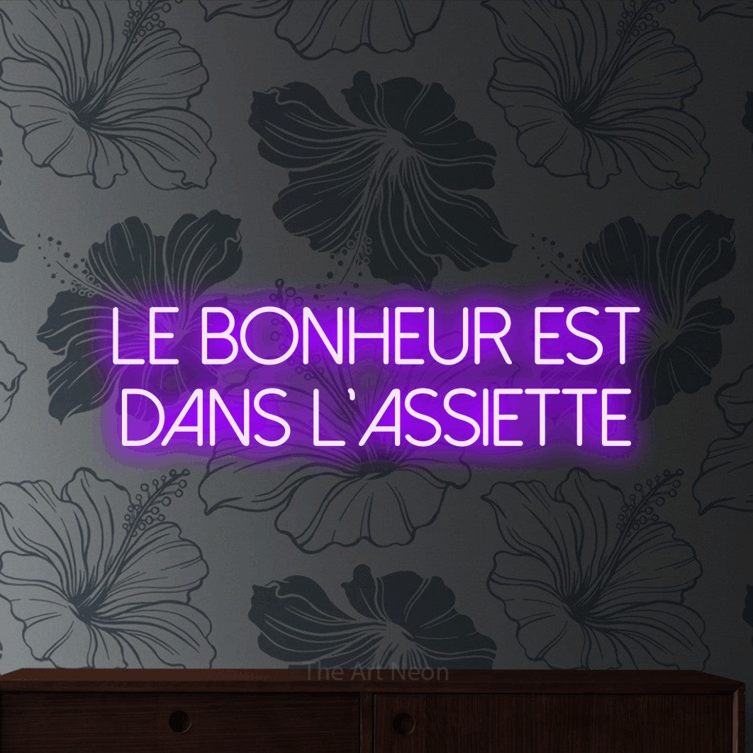 LED neon sign reading “Le bonheur est dans l'assiette”, arranged in 2 lines.