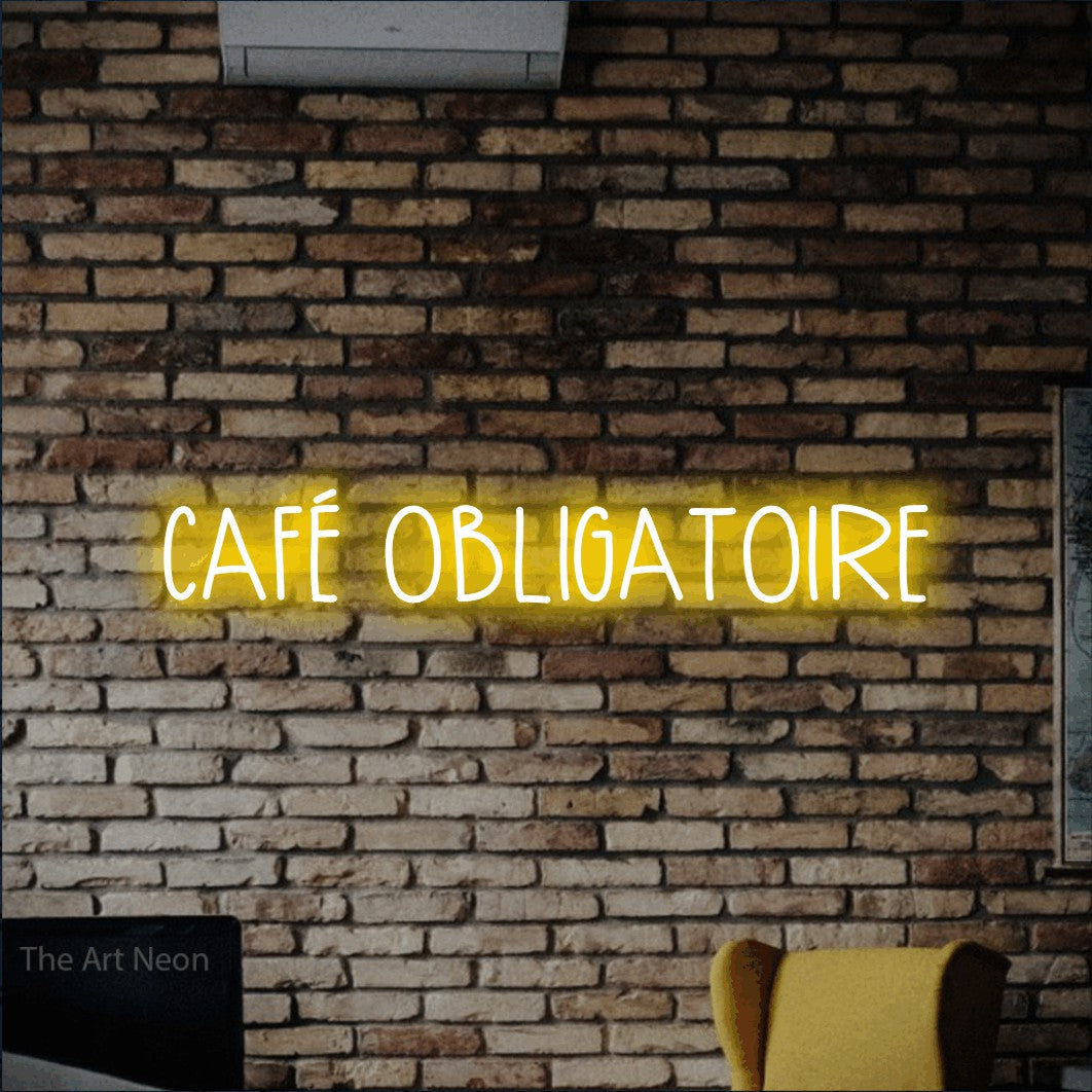 LED neon sign reading “CAFÉ OBLIGATOIRE”, arranged in a single line.