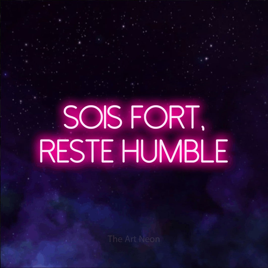 LED neon sign reading “SOIS FORT, RESTE HUMBLE”, arranged in 2 lines.