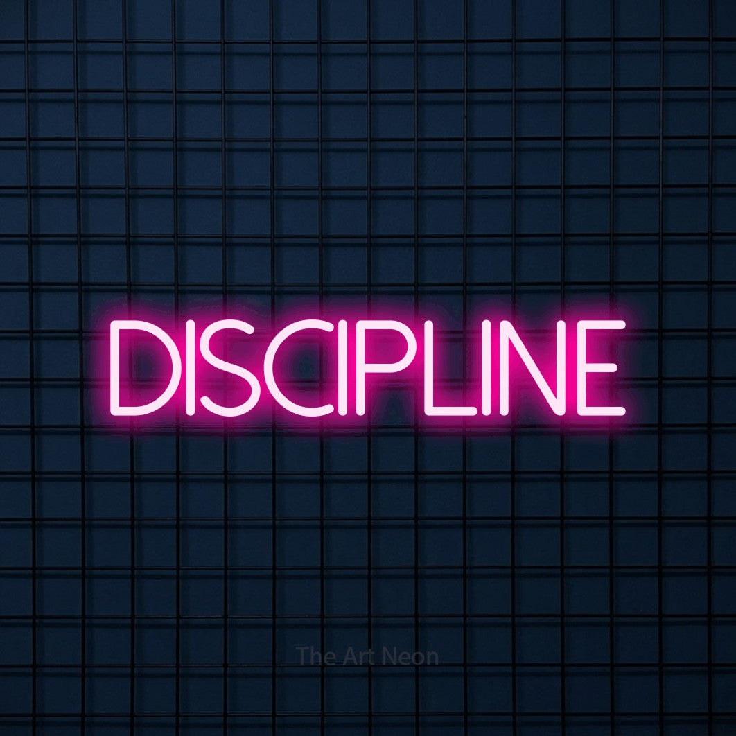 LED neon sign reading “DISCIPLINE”, arranged in a single line.