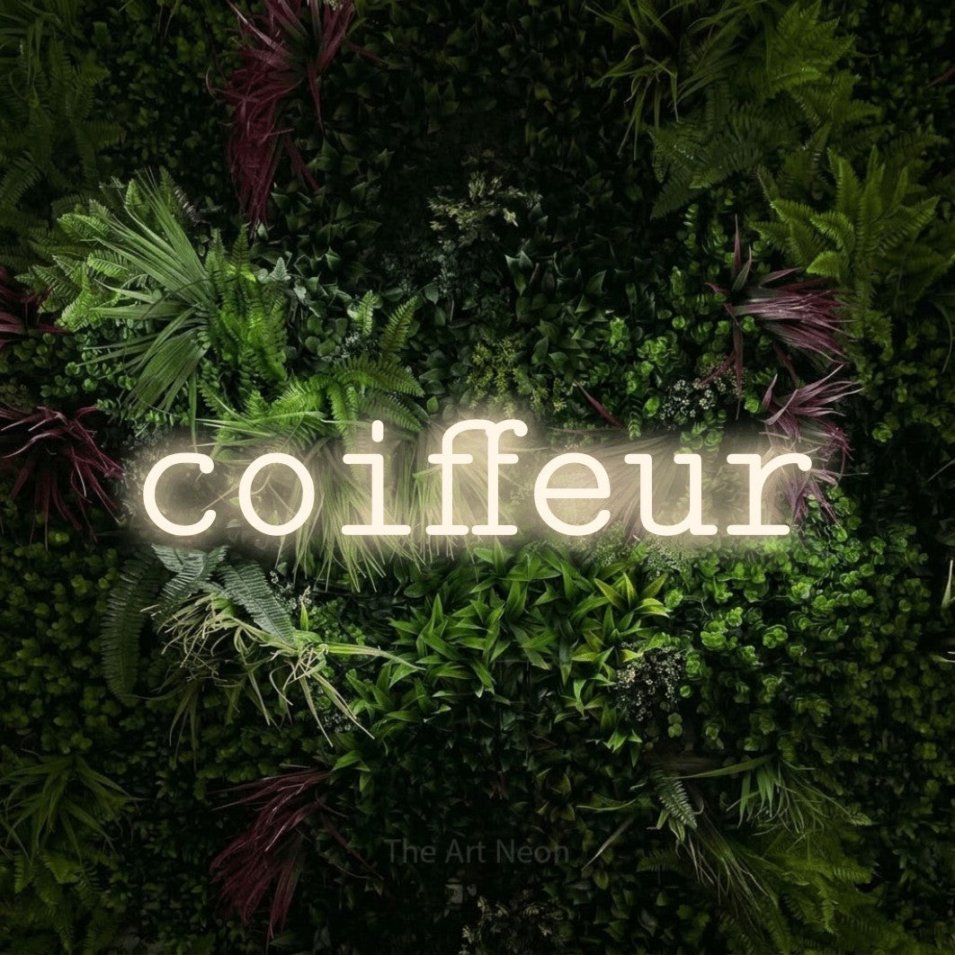 LED neon sign reading “coiffeur”, arranged in a single line.