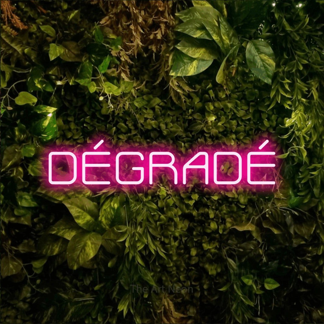 LED neon sign reading “DÉGRADÉ”, arranged in a single line.