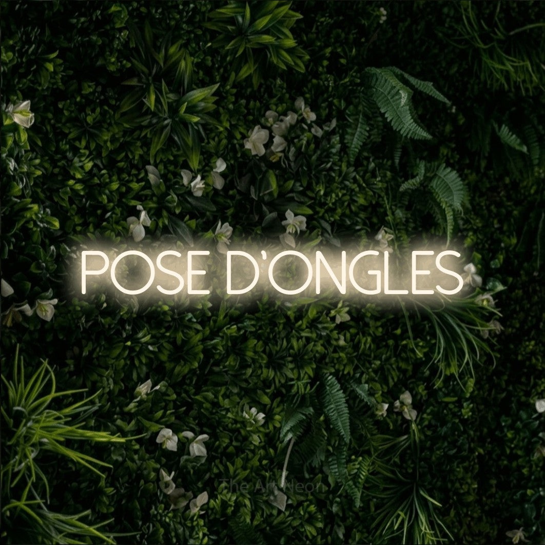 LED neon sign reading “pose d'ongles”, arranged in a single line.