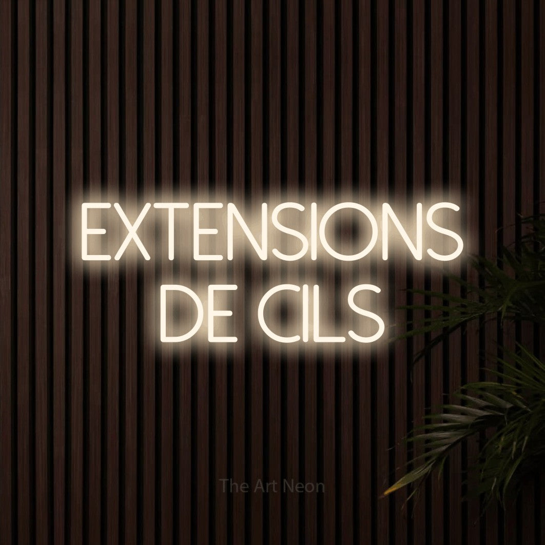 LED neon sign reading “Extensions De Cils”, arranged in 2 lines.