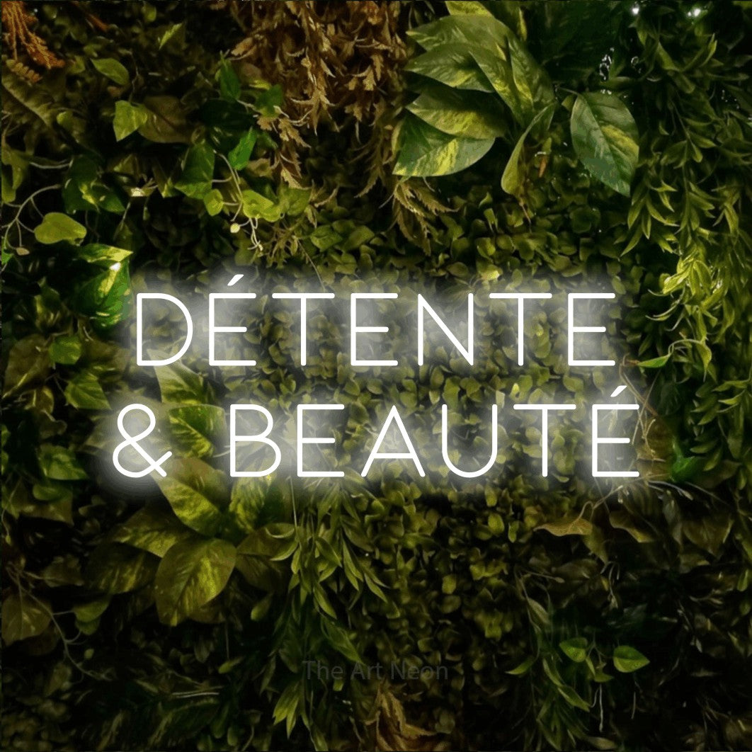 LED neon sign reading “détente & beauté”, arranged in 2 lines.