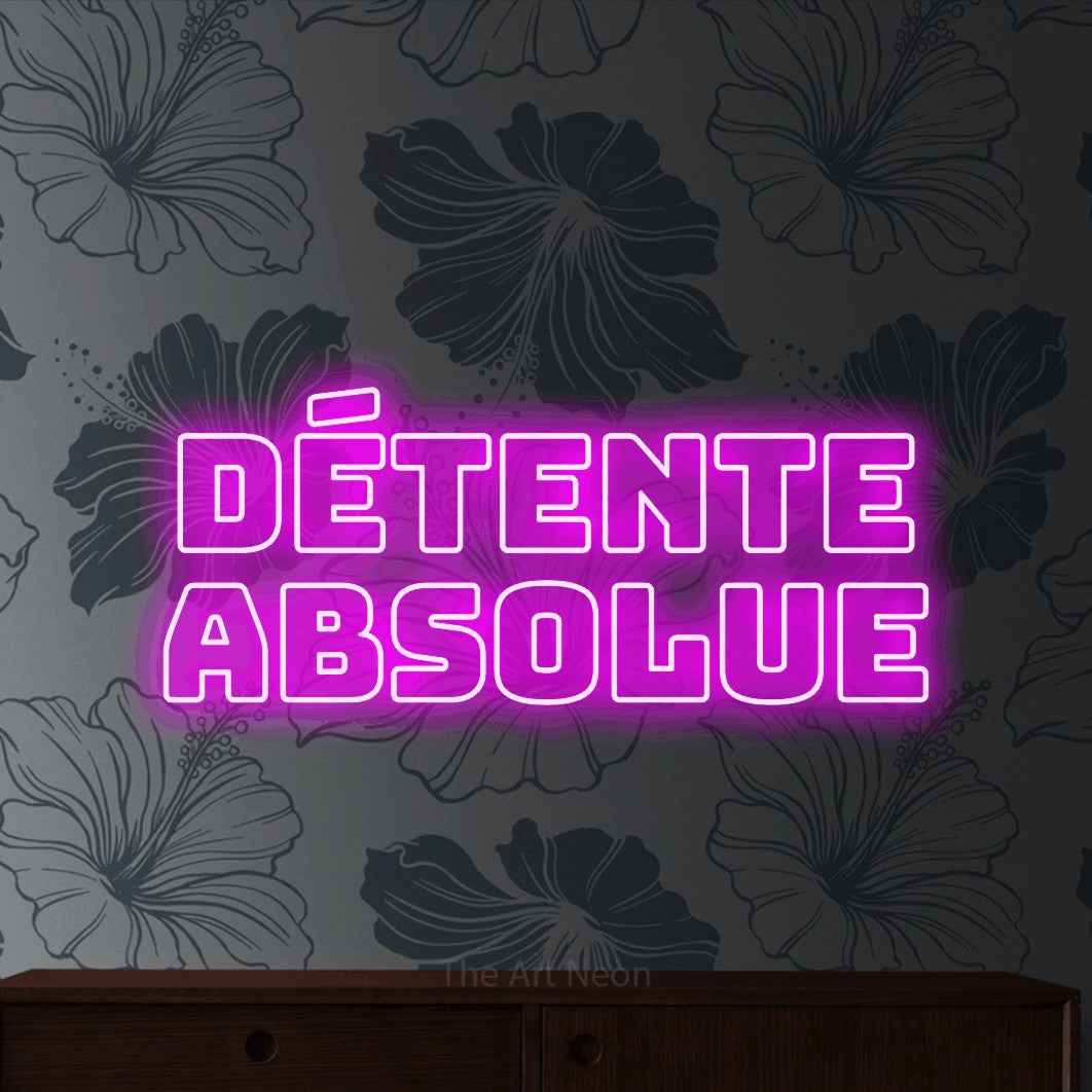 LED neon sign reading “DÉTENTE absolue”, arranged in 2 lines.