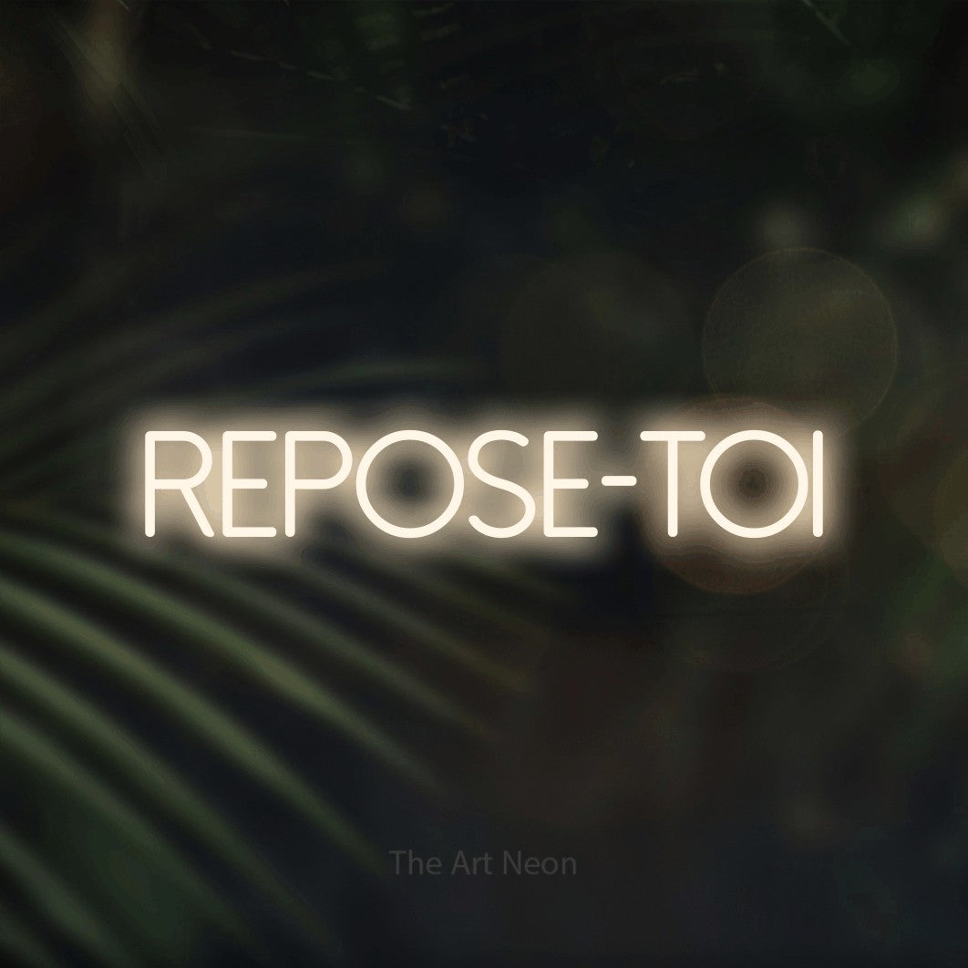 LED neon sign reading “REPOSE-TOI”, arranged in a single line.