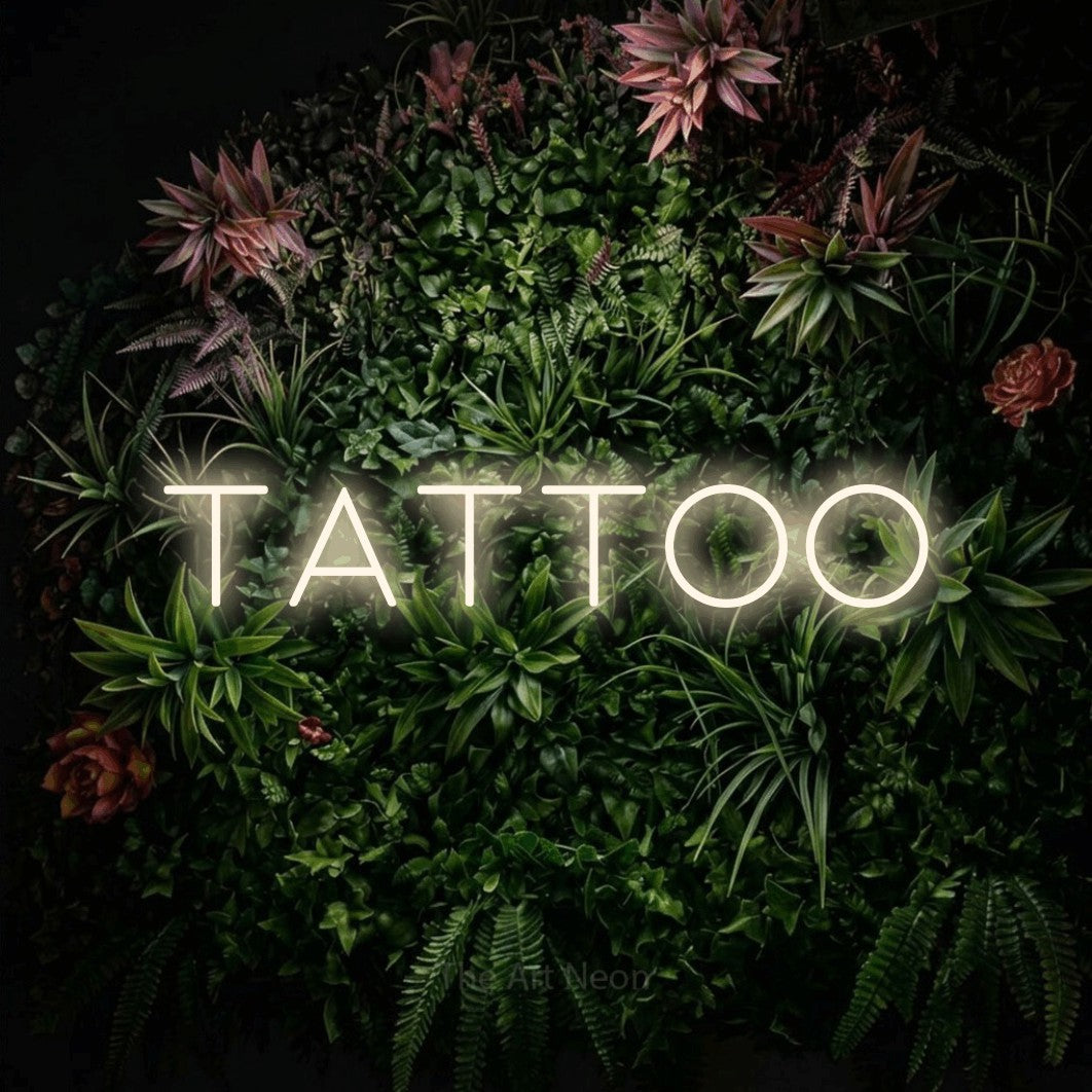 LED neon sign reading “tattoo”, arranged in a single line.
