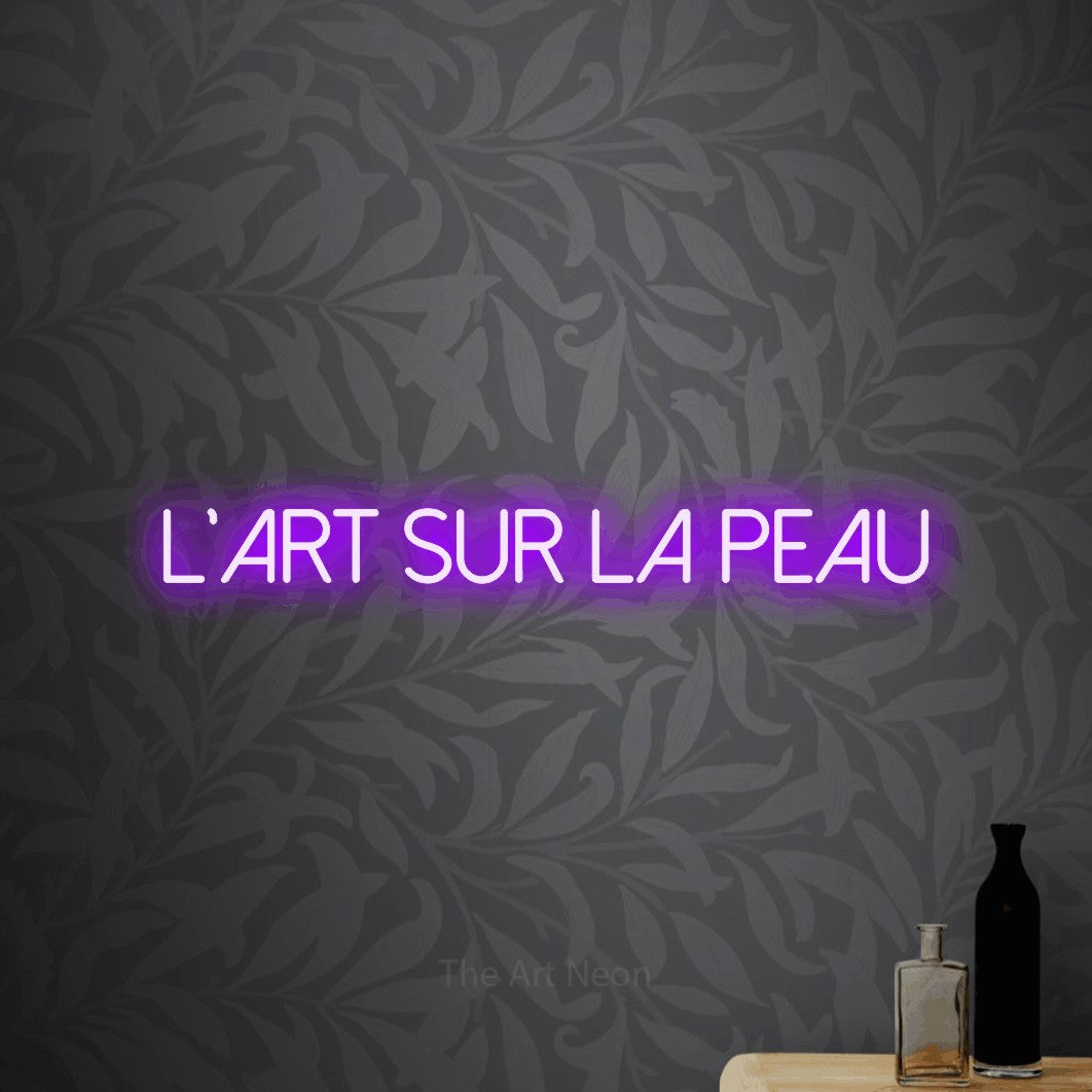 LED neon sign reading “L'Art Sur La Peau”, arranged in a single line.