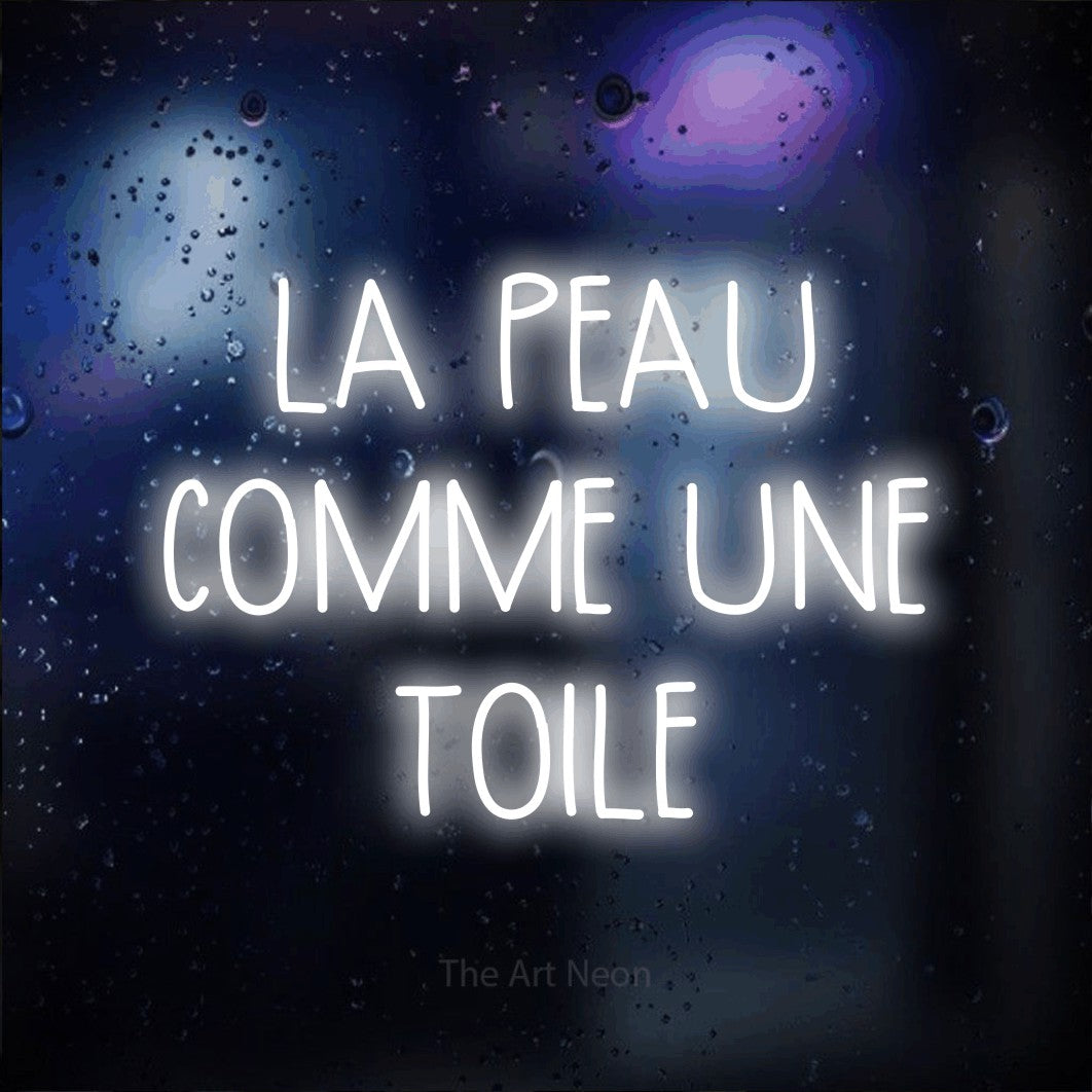 LED neon sign reading “LA PEAU COMME UNE TOILE”, arranged in 3 lines.