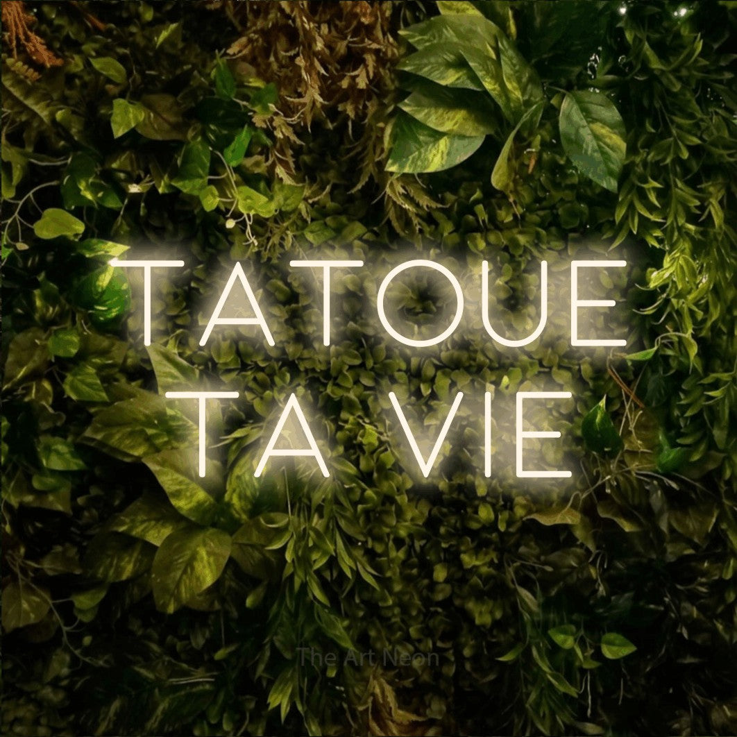 LED neon sign reading “Tatoue Ta Vie”, arranged in 2 lines.