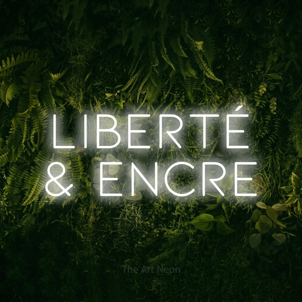 LED neon sign reading “Liberté & Encre”, arranged in 2 lines.