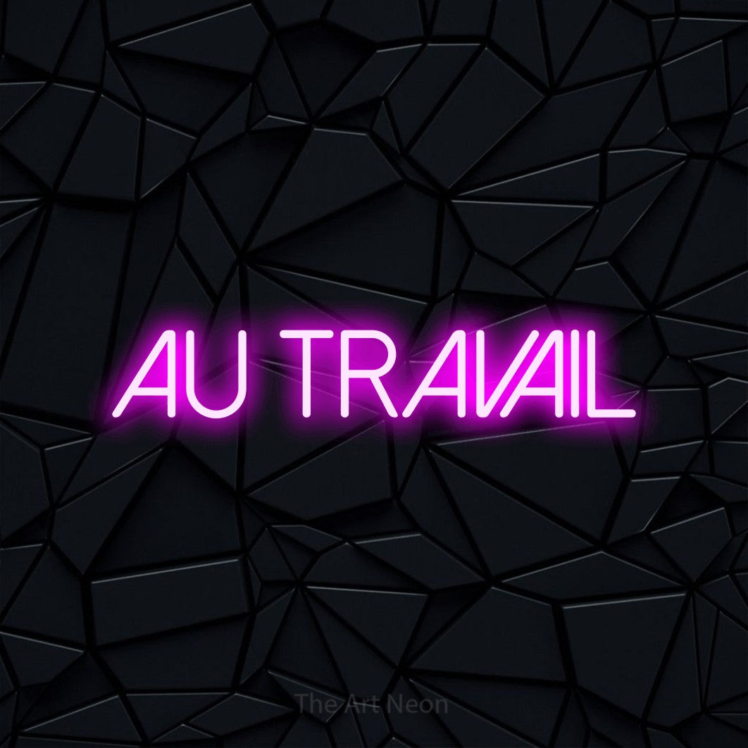 LED neon sign reading “AU TRAVAIL”, arranged in a single line.