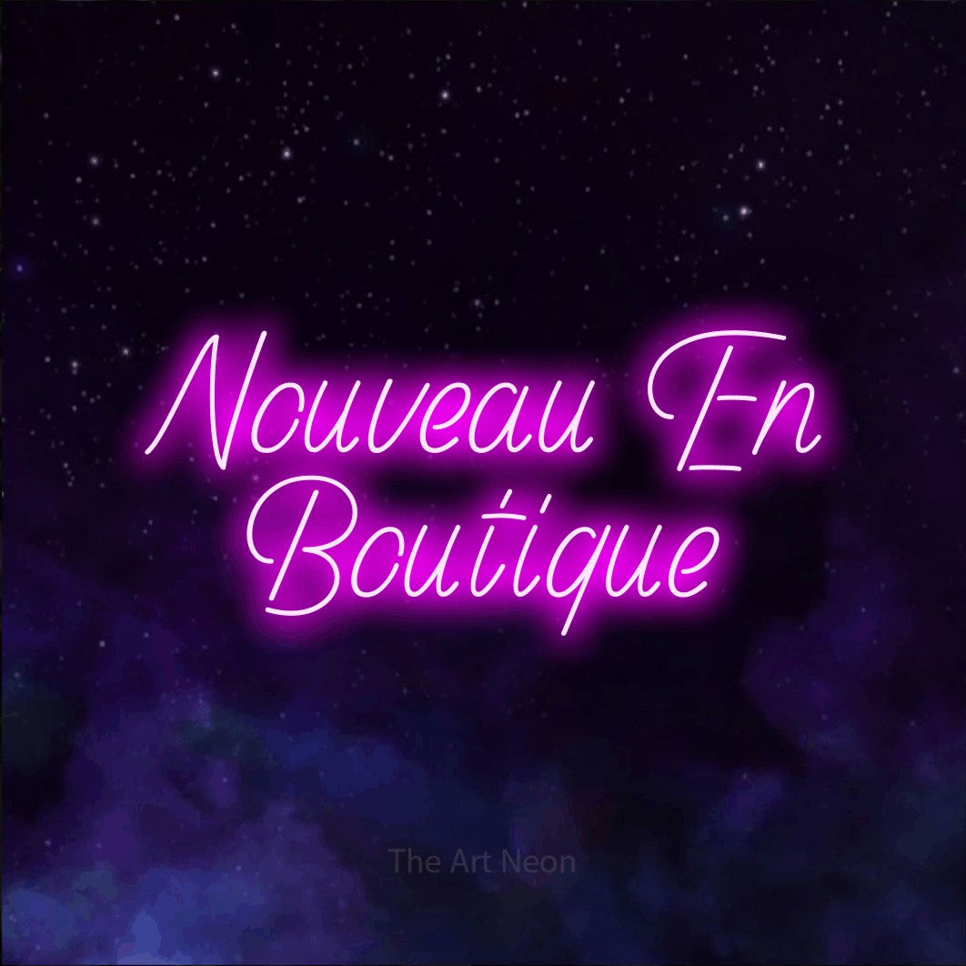 LED neon sign reading “Nouveau En Boutique”, arranged in 2 lines.