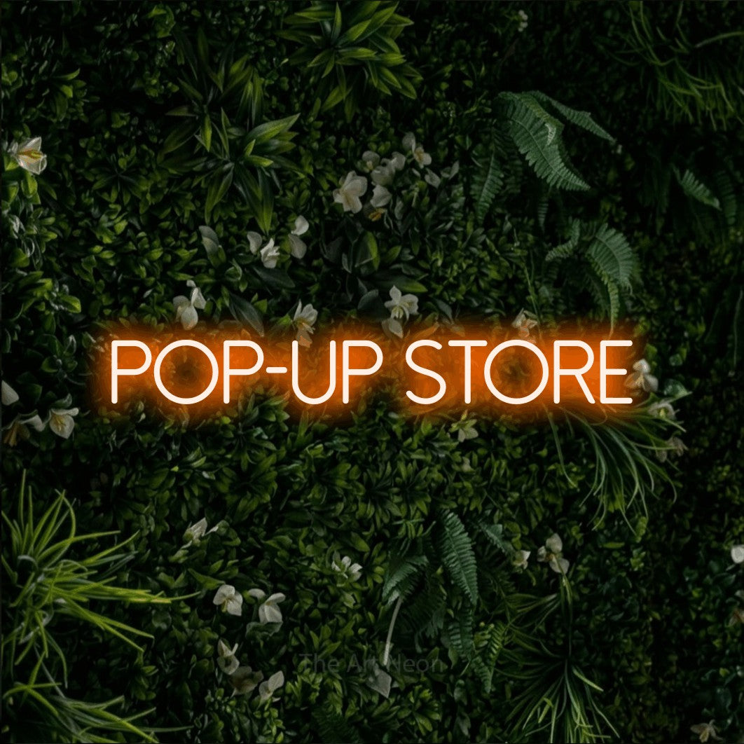 LED neon sign reading “POP-UP store”, arranged in a single line.