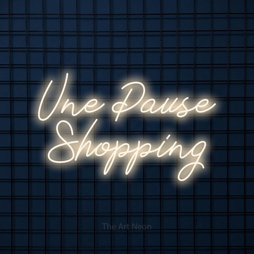 LED neon sign reading “Une Pause Shopping”, arranged in 2 lines.