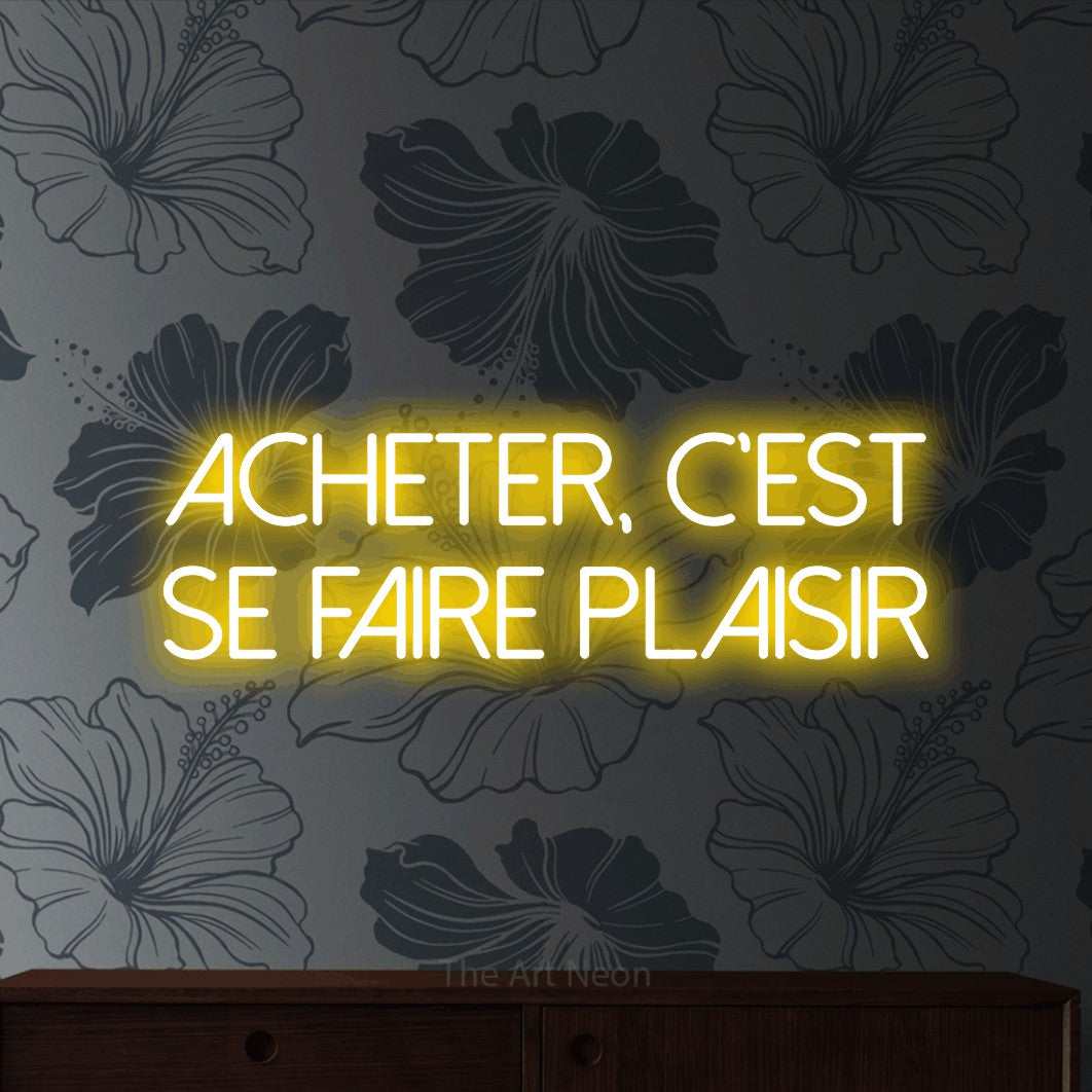 LED neon sign reading “Acheter, c'est se faire plaisir”, arranged in 2 lines.