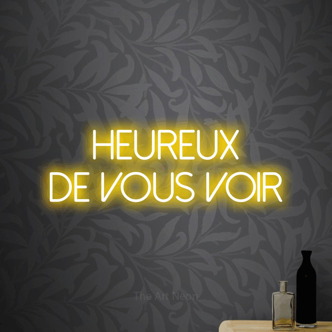 LED neon sign reading “HEUREUX DE VOUS VOIR”, arranged in 2 lines.