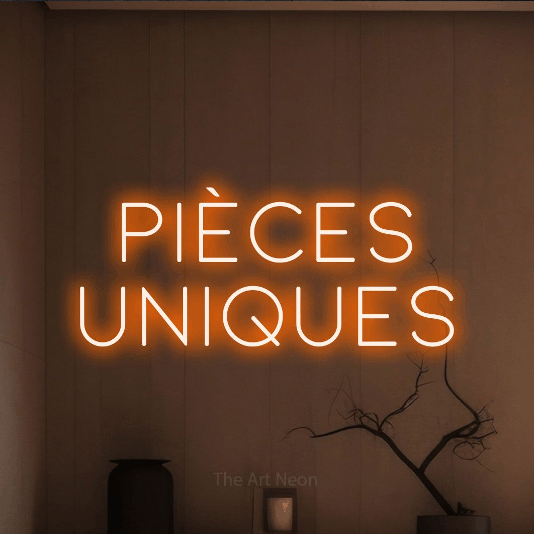 LED neon sign reading “Pièces Uniques”, arranged in 2 lines.