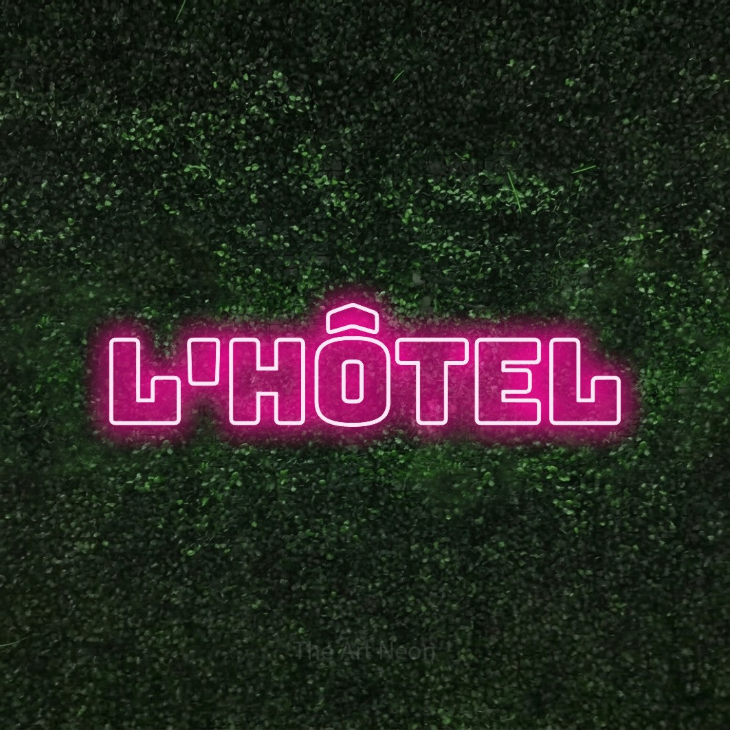 LED neon sign reading “l'hôtel”, arranged in a single line.