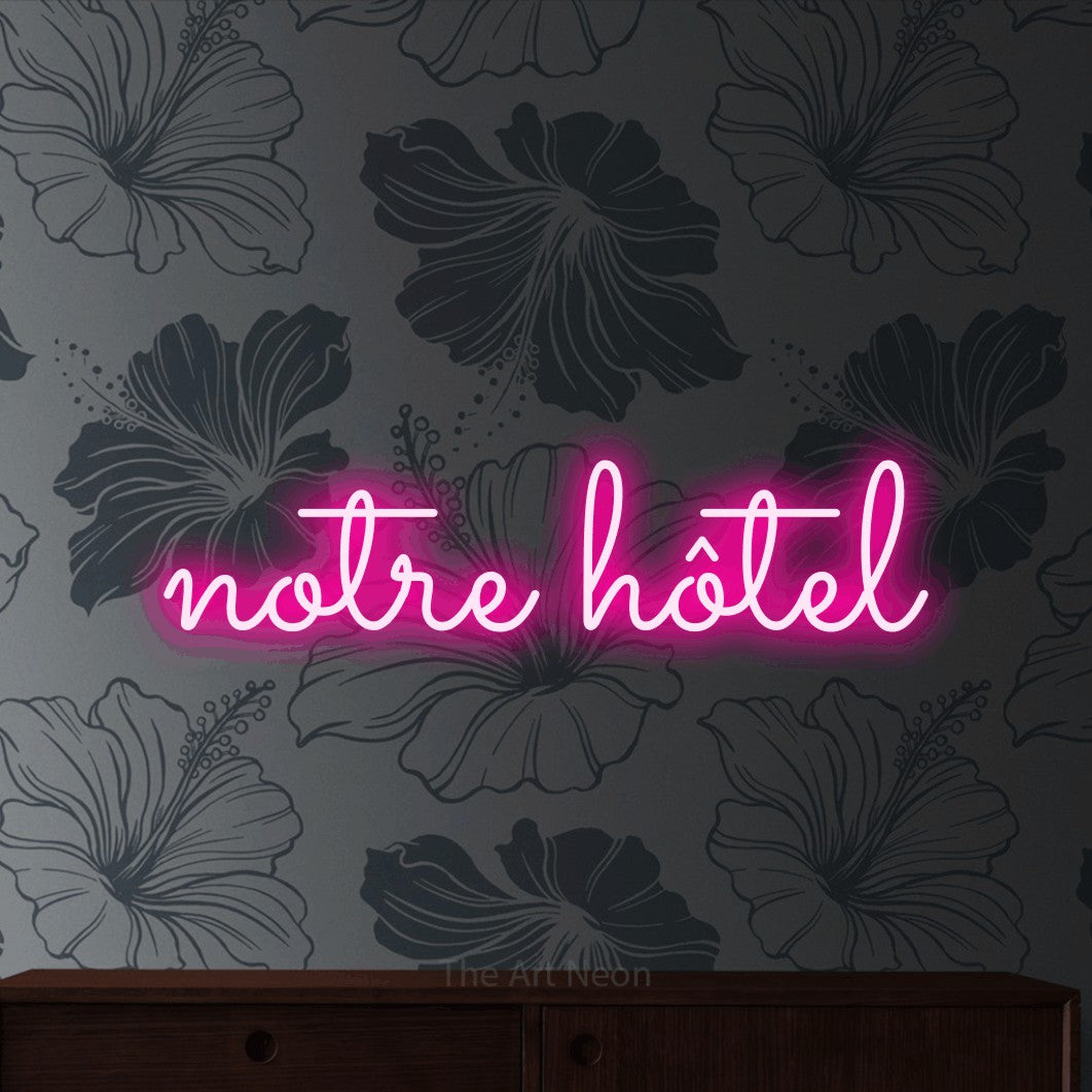 LED neon sign reading “notre hôtel”, arranged in a single line.