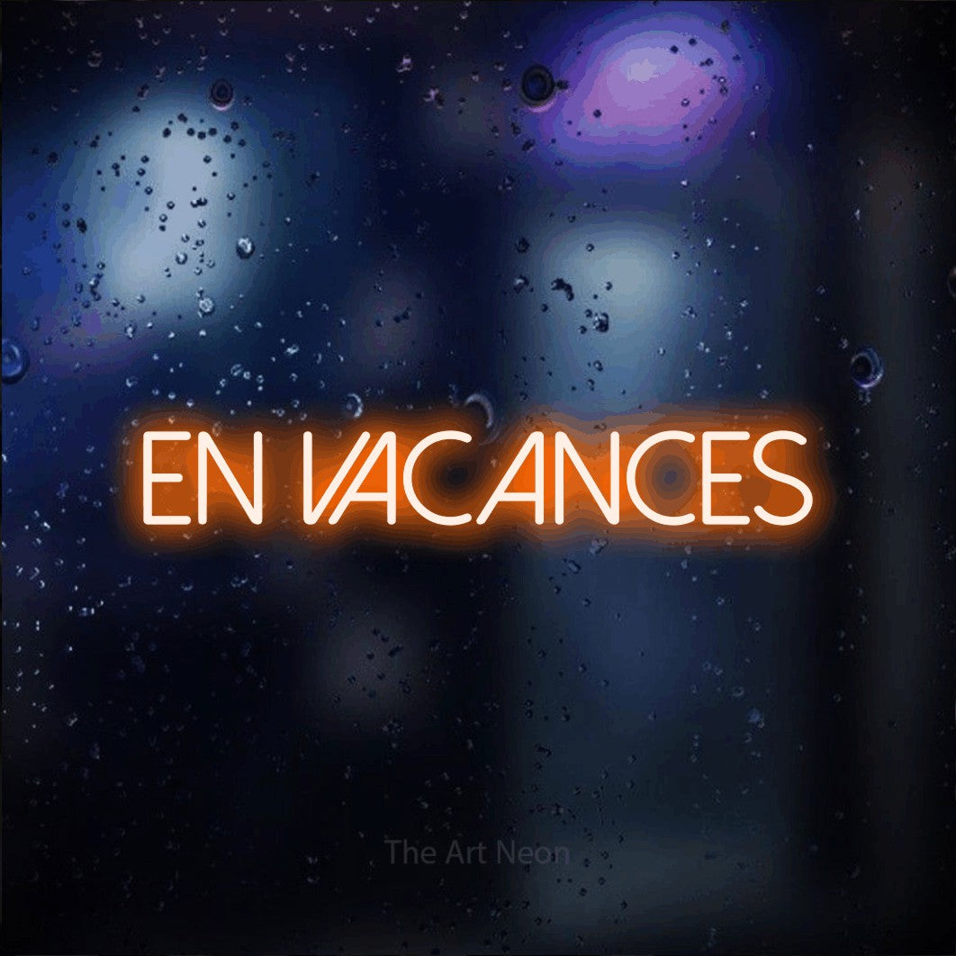 LED neon sign reading “en vacances”, arranged in a single line.