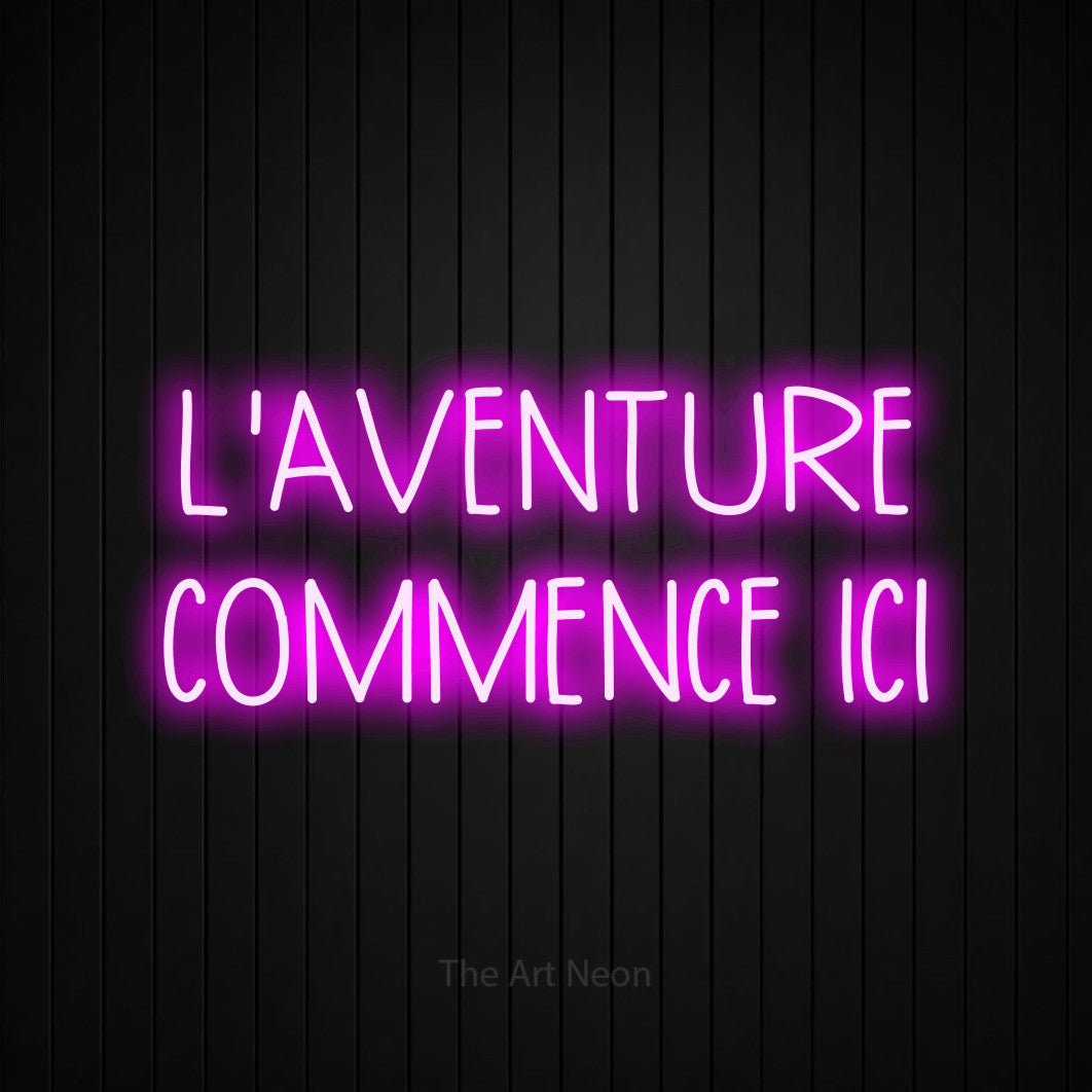 LED neon sign reading “L'AVENTURE COMMENCE ICI”, arranged in 2 lines.