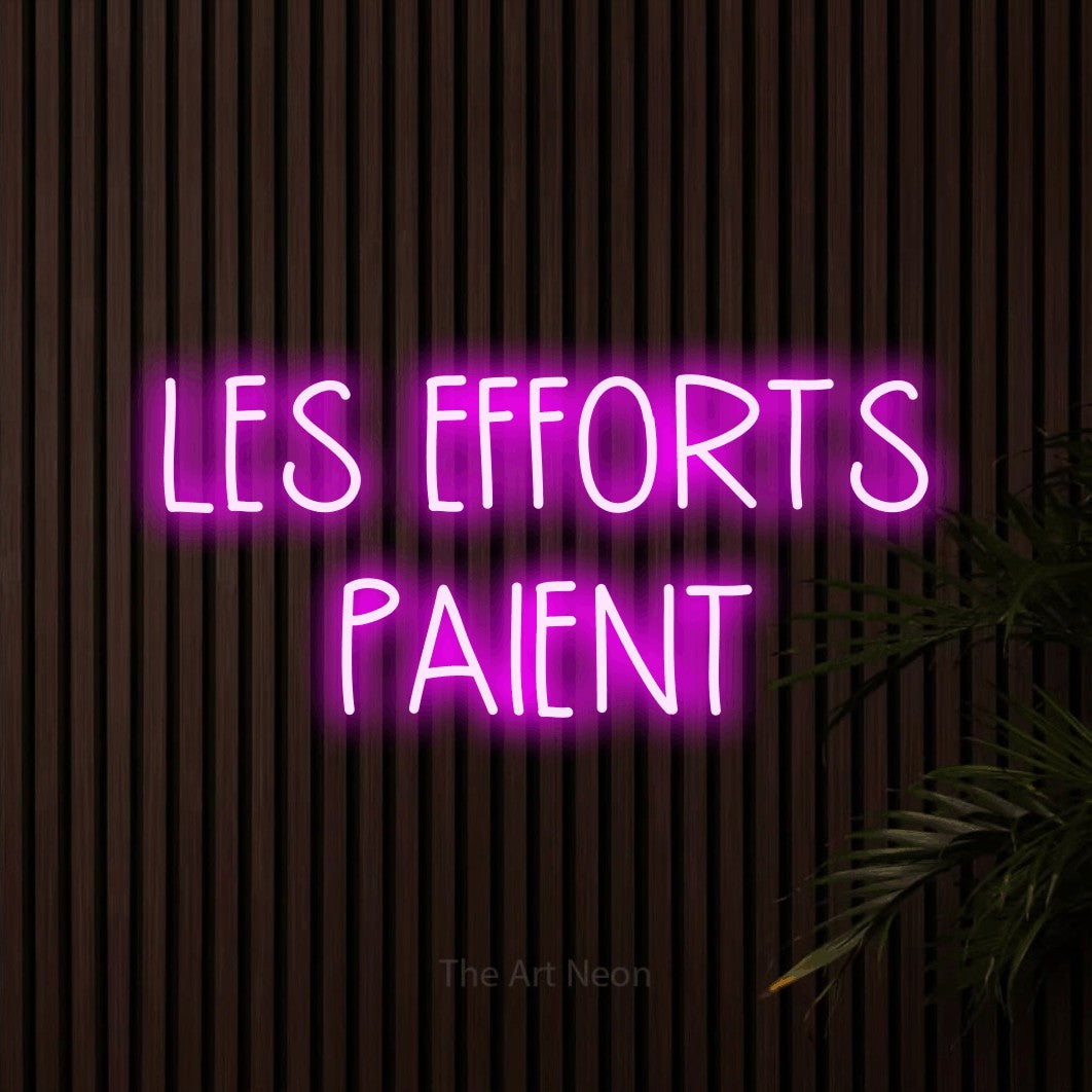 LED neon sign reading “LES EFFORTS PAIENT”, arranged in 2 lines.