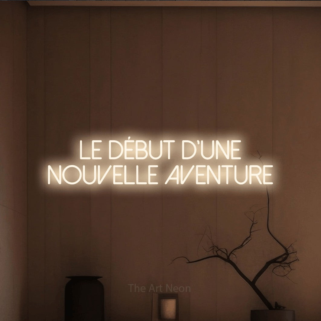 LED neon sign reading “Le début d'une nouvelle aventure”, arranged in 2 lines.