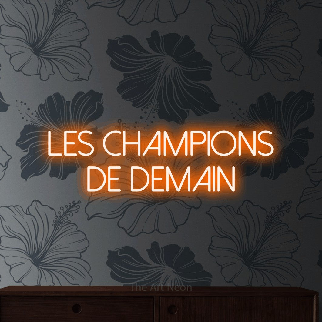 LED neon sign reading “les champions de demain”, arranged in 2 lines.